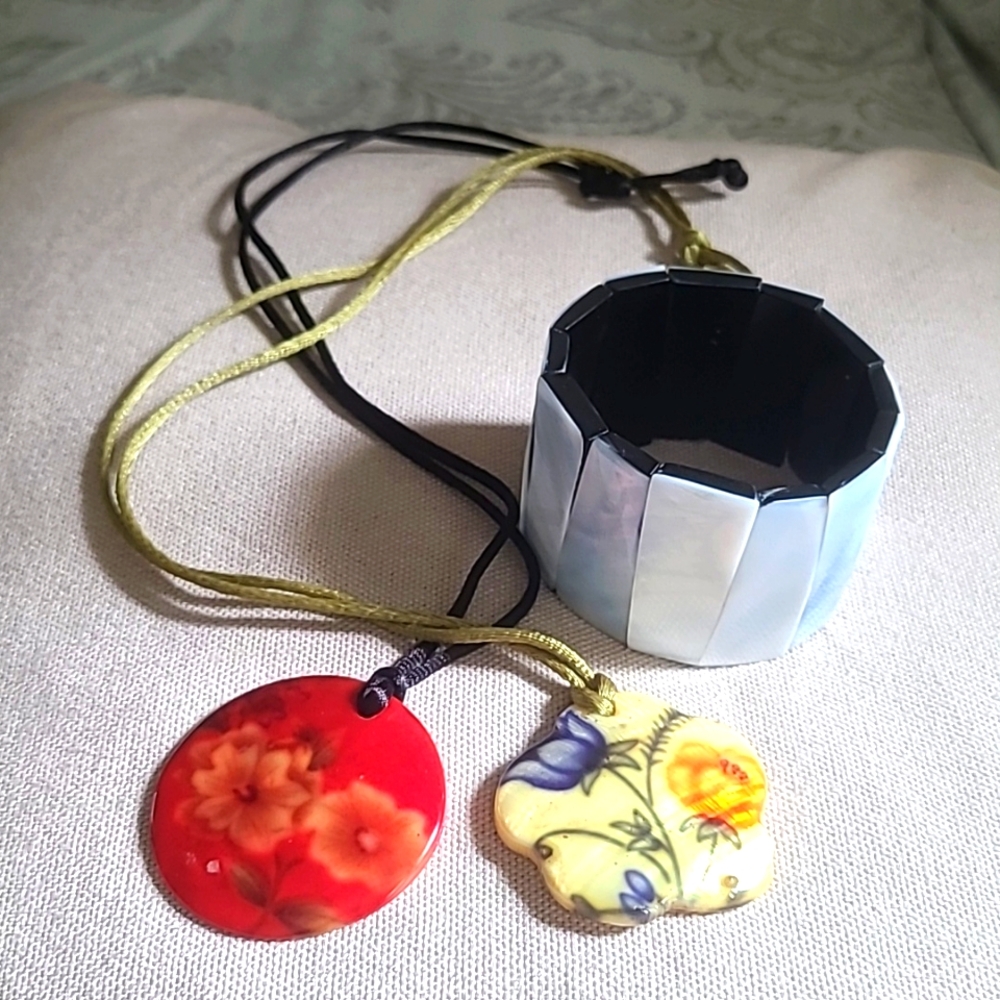 1 red and 1 yellow shell necklace and a 1 white shell bracelet.